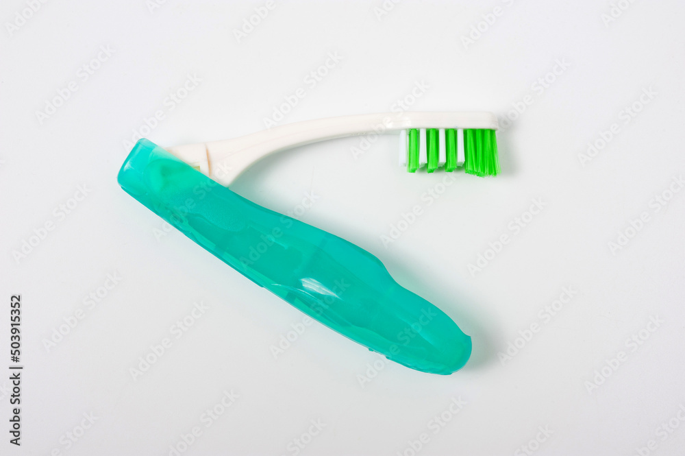 Folding plastic toothbrush for travel and tourism, shot on a white background.