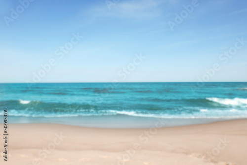 Blurred view of beautiful sea and sandy beach on sunny day © New Africa