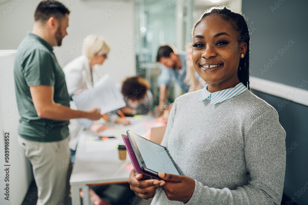 Businesswoman posing and smiling during a meeting in an office Businesswoman posing and smiling during a meeting in an office