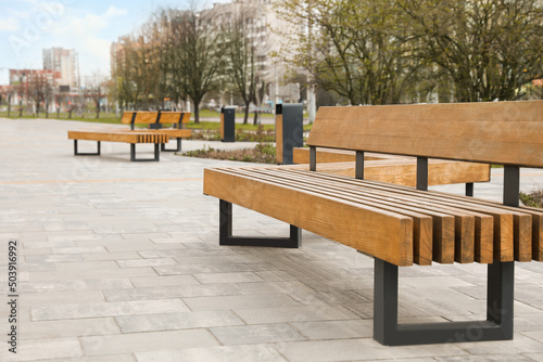 Paved city street with comfortable wooden benches