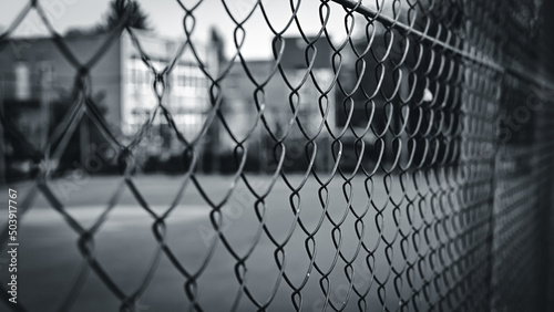 chain link fence against a basketball court