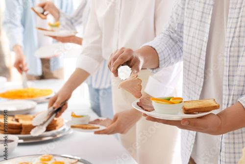 People taking food during breakfast  closeup. Buffet service