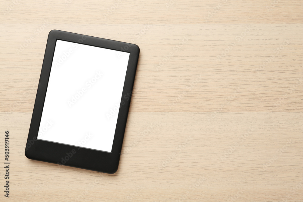 Modern e-book reader with blank screen on wooden table, top view. Space for text Modern e-book reader with blank screen on wooden table, top view. Space for text