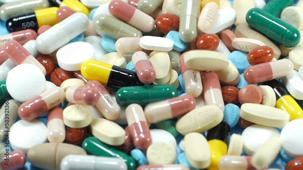 Close up slow motion medicine multi color of pills rotation and pour the drug isolated on white background.Macro video. Close up slow motion medicine multi color of pills rotation and pour the drug isolated on white background.Macro video.