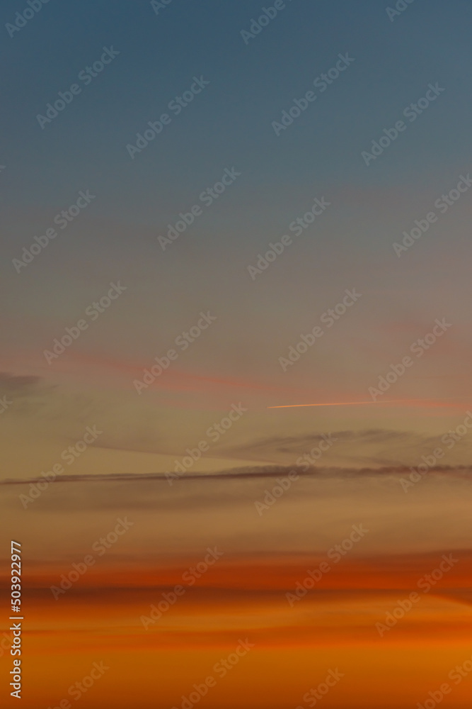 Cover page with gradient soft deep orange sky, illuminated clouds at bloody sunset as a background.