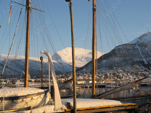 Boats in Tromso Harbour. surrounded by Snow Mountains