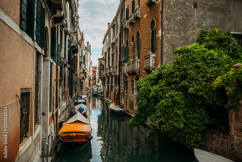 Traditional narrow canal street with old houses in Venice, Italy. Italy beauty, one of canal streets in Venice, Venezia © Strikernia