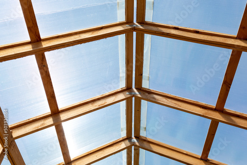 Obraz na płótnie Roof of greenhouse, barn or other agricultural building is made of transparent p