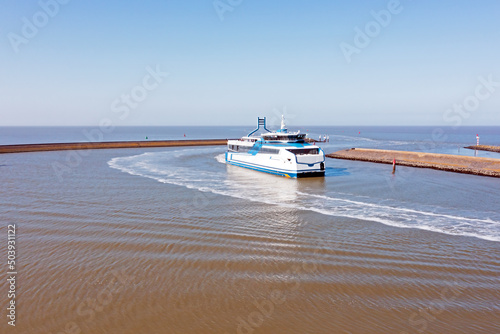 Ferry boat arriving in the harbor from Harlingen in Friesland the Netherlands Fototapet