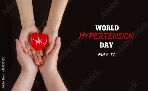 World Hypertension Day. Mom and baby holding red heart with heartbeat chart - a symbol of high blood pressure. Hypertension Day in May 17th.