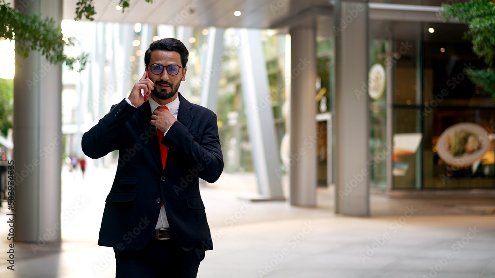 Young businessman with beard wearing eyeglasses talking on mobile phone Young businessman with beard wearing eyeglasses talking on mobile phone