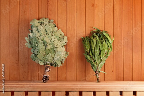 Two brooms on the shelf in the bath. Background Photo
