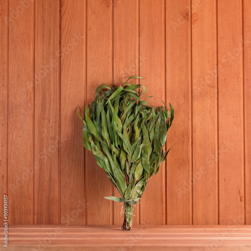 Eucalyptus broom in the Sauna on the shelf. Spa concept Photo