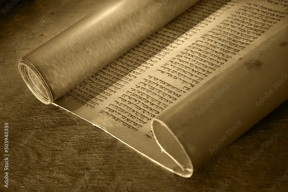 Valokuva Ancient scroll lit by candlelight