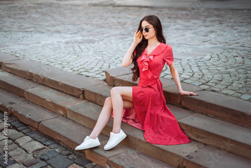 Pretty girl in retro outfit on stairs. Summertime fashion