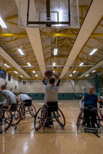 Male basketball players in wheelchairs having practice