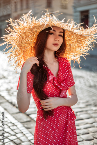 Young girl in summer outfit with straw hat