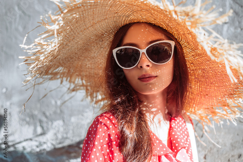 Stylish girl with sunglasses and straw hat
