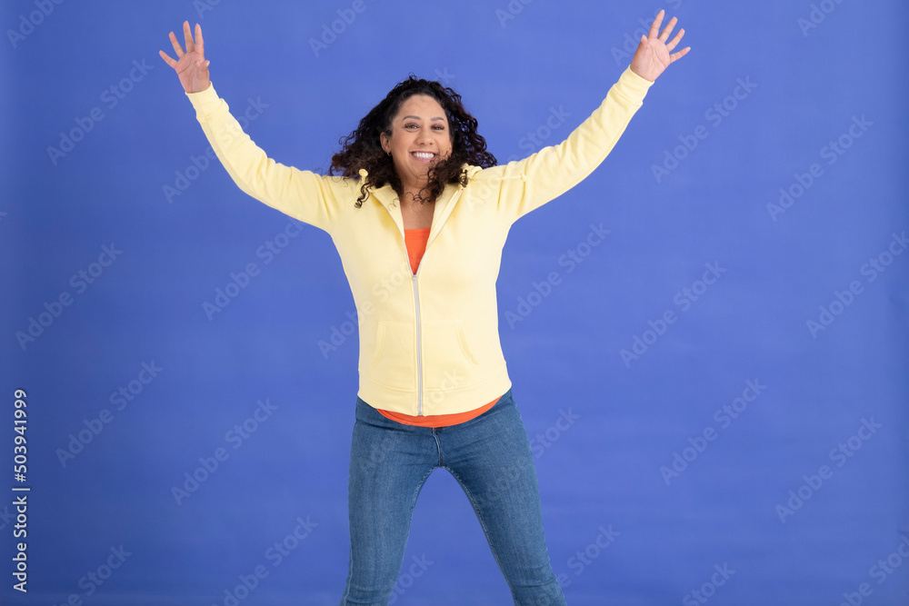 Studio portrait of mid adult woman jumping Studio portrait of mid adult woman jumping