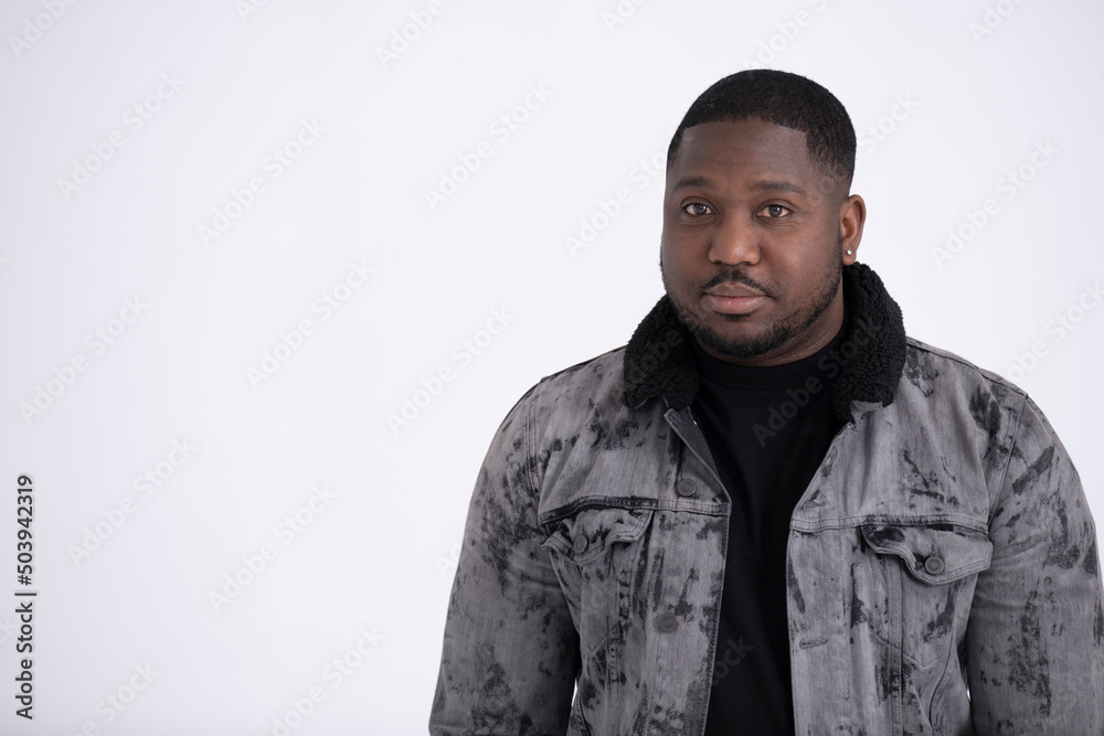Studio portrait of mid adult man wearing gray jacket