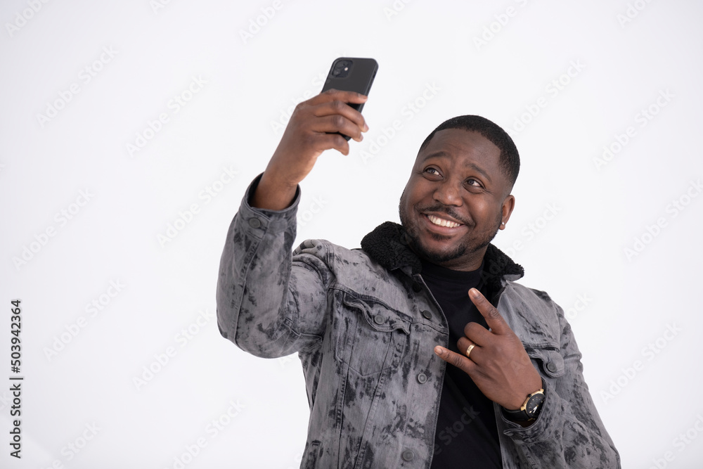 Studio portrait of mid adult man taking selfie