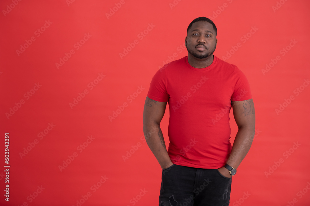 Studio portrait of mid adult wearing red t-shirt Studio portrait of mid adult wearing red t-shirt
