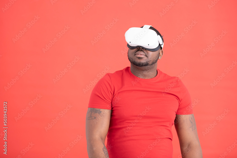 Studio shot of man wearing VR goggles