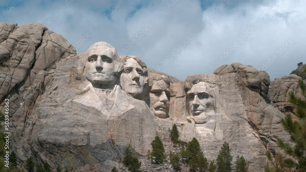 A time lapse shot of Mount Rushmore in South Dakota captured on a partly cloudy day.
