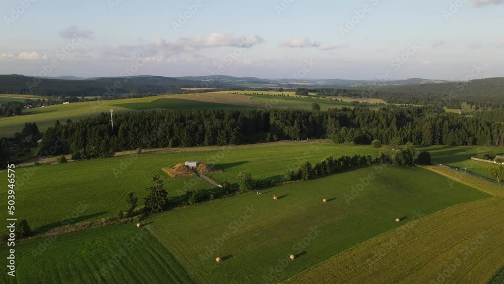 Aerial drone view of meadow near village and forest. Summer in Czechia Aerial drone view of meadow near village and forest. Summer in Czechia