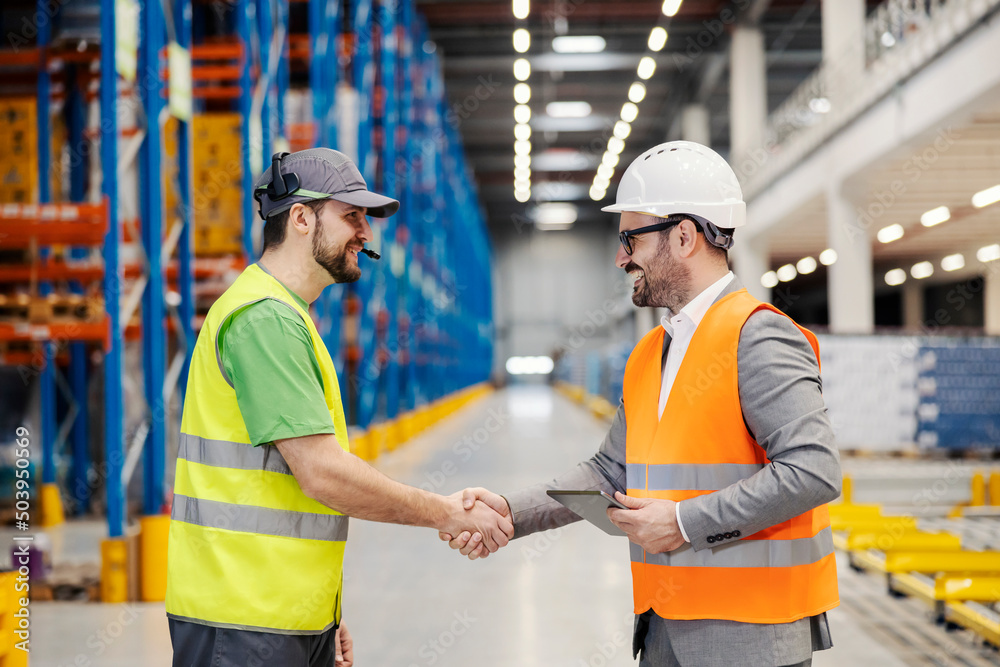 A storage worker shaking hands with supervisor. A storage worker shaking hands with supervisor.