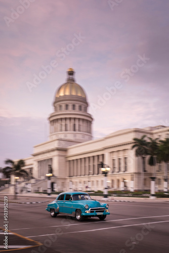 Old car on streets of Havana with Capitolio building in background. Cuba © danmir12