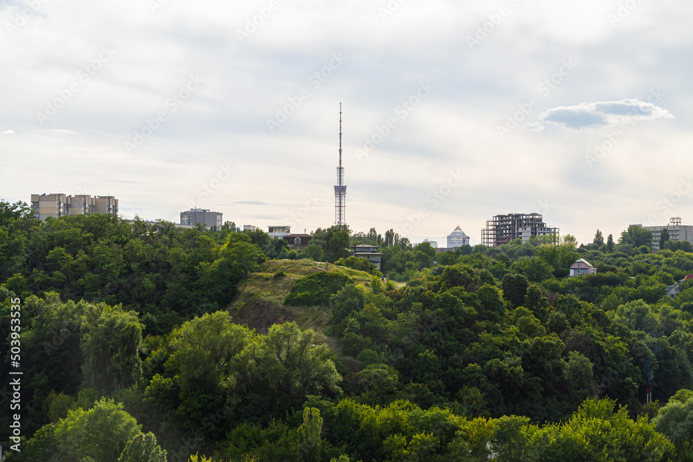 Obraz premium Kyiv, Ukraine – July 08, 2017: A beautiful panorama of Podil area. Aerial view on residential and industrial areas. A lot of buildings of different architectural style. Historical area, Dnipro river.