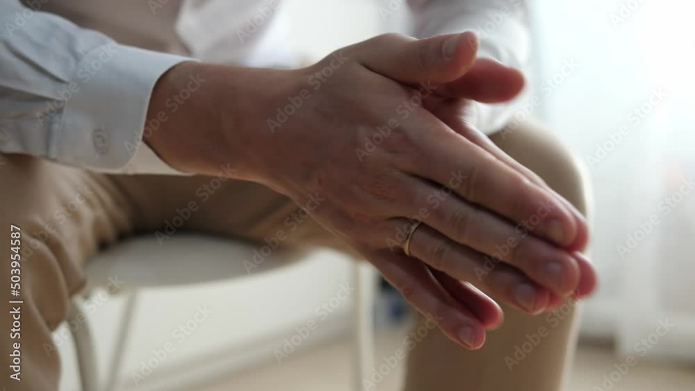Close-up of the hands of a tense businessman rubbing his hands, nervous. The concept of mental health at work. Close-up of the hands of a tense businessman rubbing his hands, nervous. The concept of mental health at work.