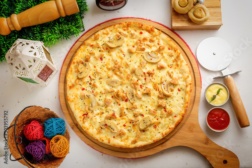 Pollo Alfredo pizza with tomato sauce and mayo isolated on wooden board top view of italian food on wooden background photo