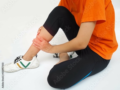 Woman hands leg massage for pain relief on a white background. closeup photo, blurred. 