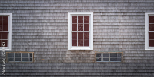 Cape Cod-style cedar siding wall with white windows