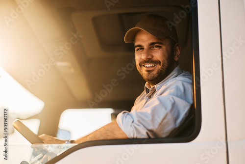 Fotografia, Obraz Portrait of happy truck driver looking at camera.