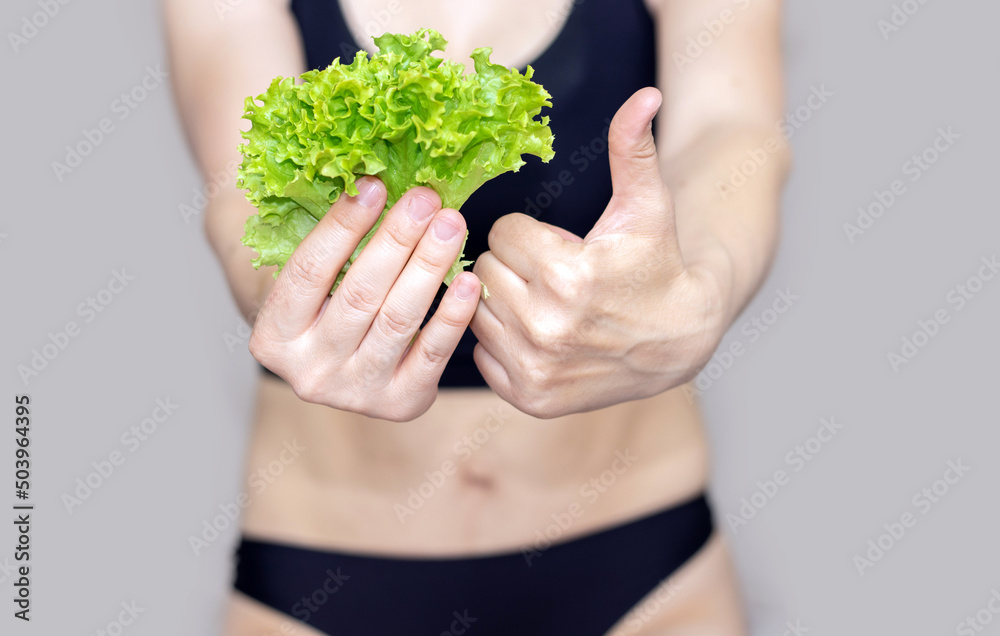 fit,slim,sexy girl with green salad lettuce leaf holded with underwear or in hand, finger thumbs up. healthy food, nutrition and fitness concept. afterchild belly, motherhood. isolated,no face fit,slim,sexy girl with green salad lettuce leaf holded with underwear or in hand, finger thumbs up. healthy food, nutrition and fitness concept. afterchild belly, motherhood. isolated,no face