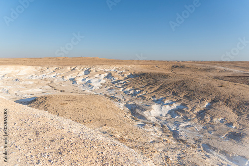 Beautiful lunar landscape. Wight and smooth hills in various shapes in a desert landscape. The whitish, rounded, winding, and smooth chalk rocks. Israel. High quality photo