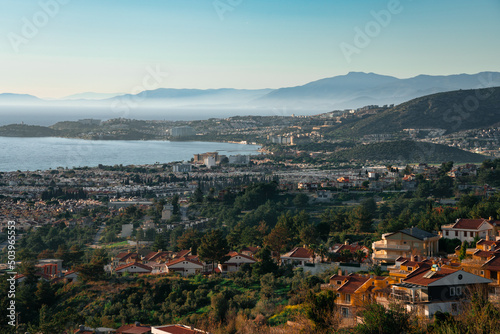 Panorama of Kusadasi city in Turkey with Long Beach and villas in the foreground and mountains and sea in background. © Grelafoto
