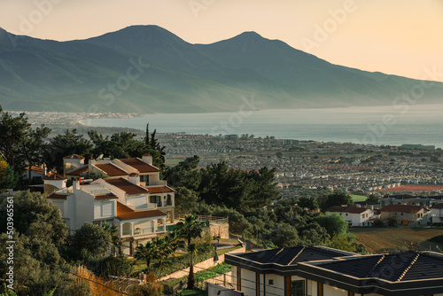 Kusadasi Long Beach panorama with luxury villas and National Park hills in the background