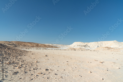 Beautiful lunar landscape. Wight and smooth hills in various shapes in a desert landscape. The whitish, rounded, winding, and smooth chalk rocks. Israel. High quality photo