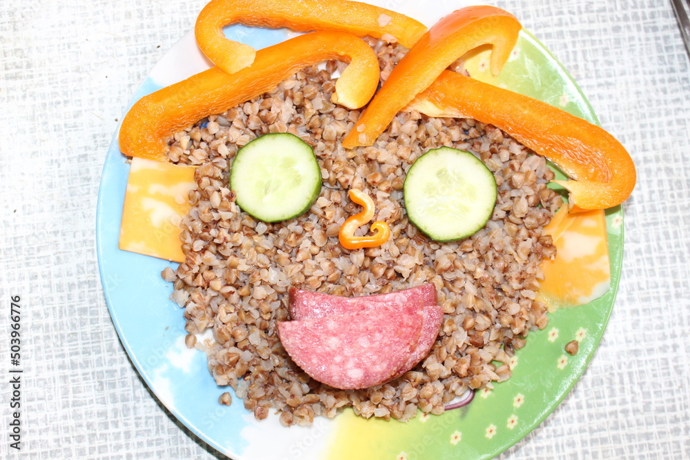 custom made wallpaper toronto digitalBreakfast for a child is decorated in the form of a funny face in a plate. Buckwheat, pepper, cucumber, cheese, sausage are good for the body
