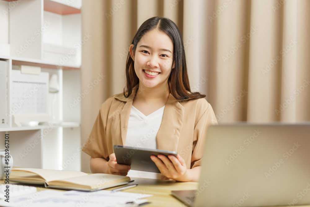 Online lifestyle concept A female staff working from home and checking the meeting report through the tablet. Online lifestyle concept A female staff working from home and checking the meeting report through the tablet.
