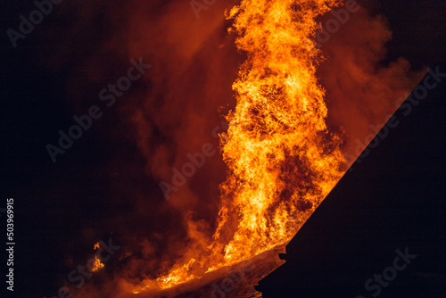 House on fire at night. Topics of arson and fires, disasters and extreme events. photo