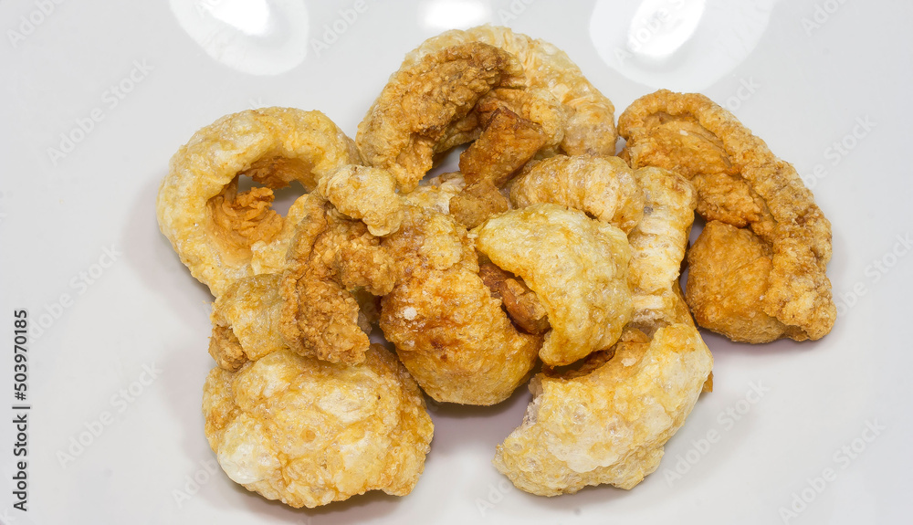 Pork skins or lean pork skins are fried to a puffy and crispy texture Pork skins or lean pork skins are fried to a puffy and crispy texture