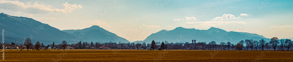 Fototapeta premium Beautiful winter view with a monastery and the alps in the background near Benediktbeuren, Bavaria, Germany
