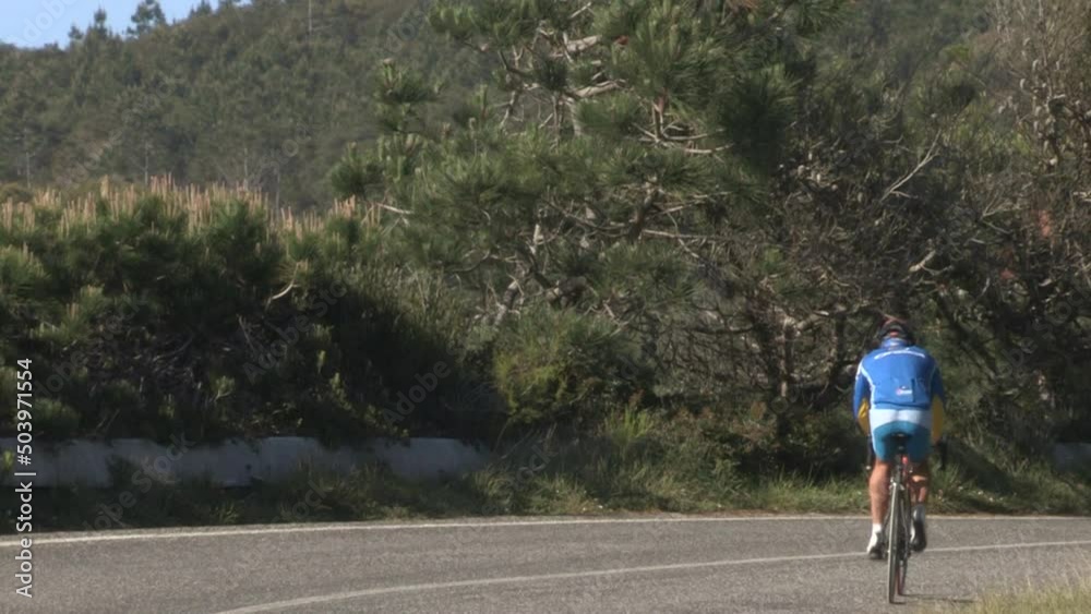 Image of a cyclist who climbs the mountain by bicycle. Image of a cyclist who climbs the mountain by bicycle.