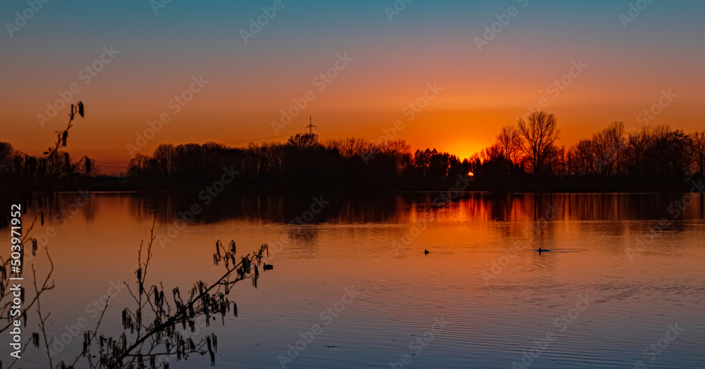 Naklejka premium Beautiful sunset with reflections near Plattling, Isar, Bavaria, Germany