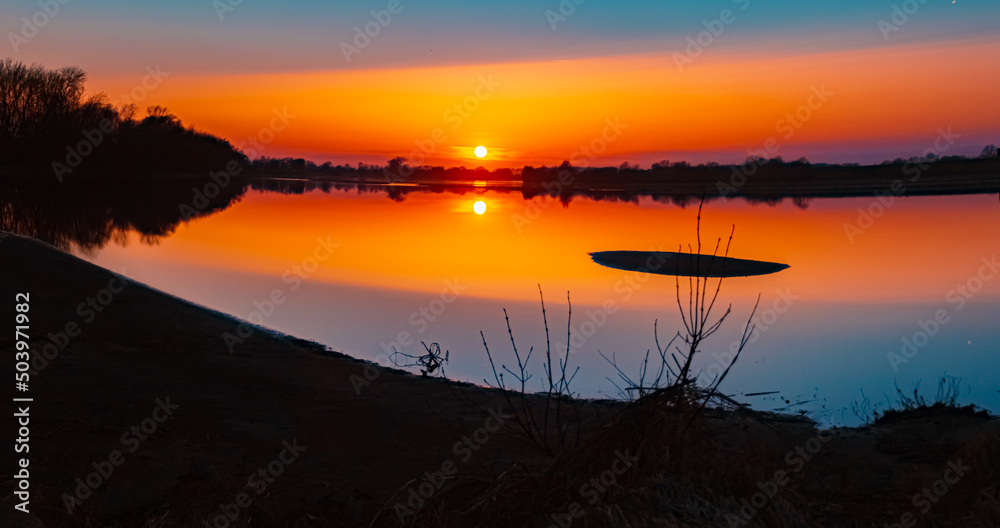Beautiful sunset with reflections near Mettenufer, Danube, Bavaria, Germany